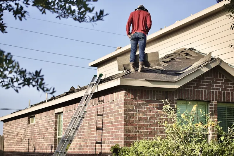Professional roofer working on a residential roof in Germany
